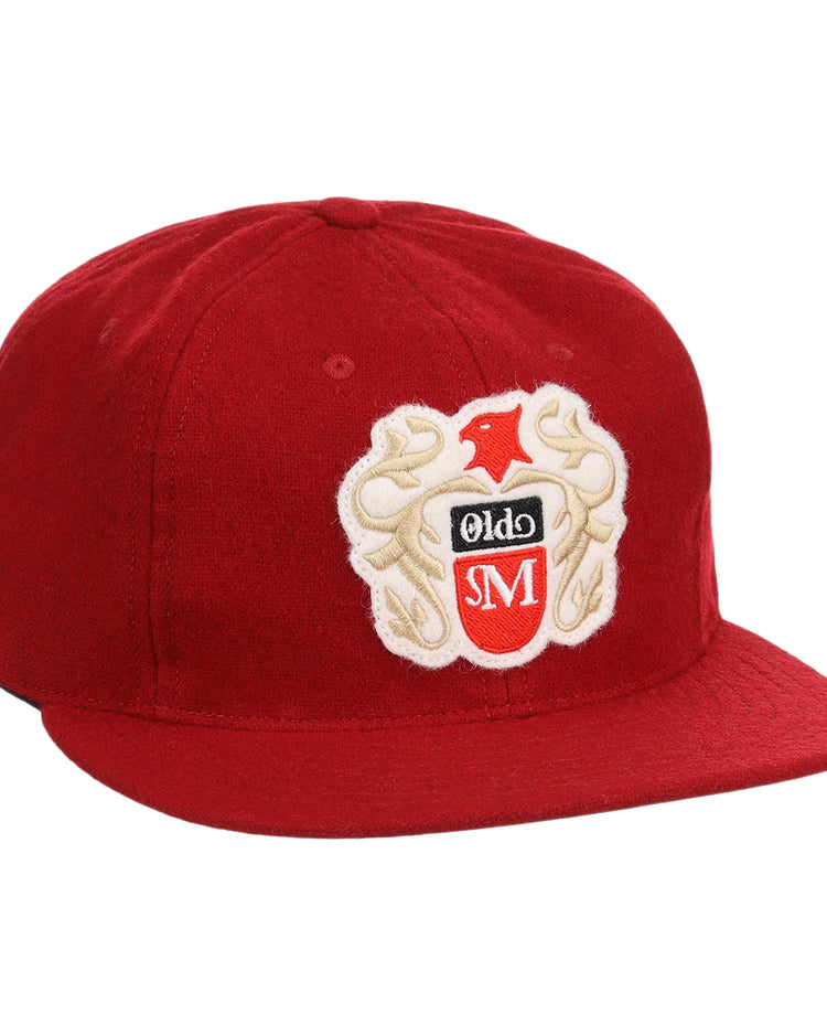 The Old Milwaukee EFF Vintage Beer Wool Ballcap by EFF is a red cap with an embroidered bird, Olde, and SM crest on the front. It features a flat brim and structured crown, ideal for classic American Lager fans.