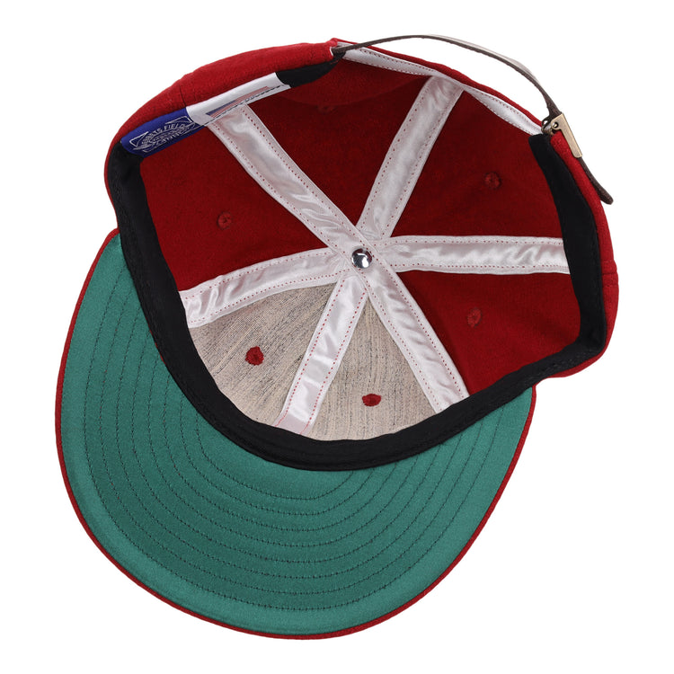 The Old Milwaukee EFF Vintage Beer Wool Ballcap by EFF features a red wool design, green underbrim, white interior seams, silver center button, and an adjustable brown strap—a classic pick for fans of vintage American Lager style.