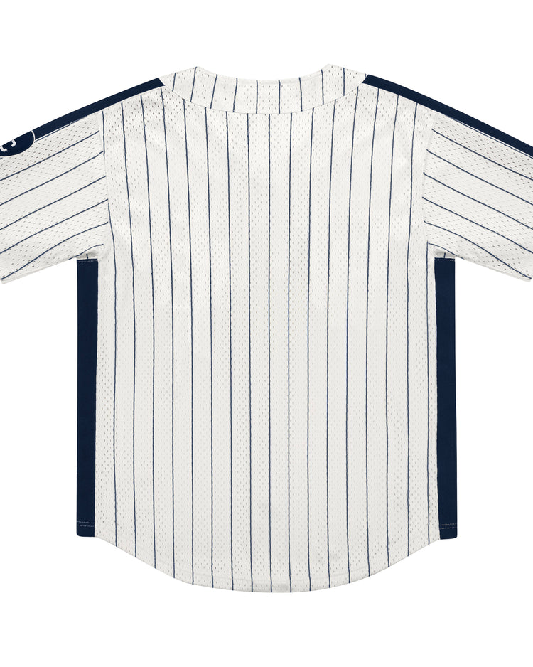 The EFF Kansas City Monarchs NLB Pinstripe Button Down Jersey features white fabric with thin navy blue pinstripes, navy side panels, and a round neckline. Shown from the back, its inspired by classic Ebbets Field Flannels jerseys.