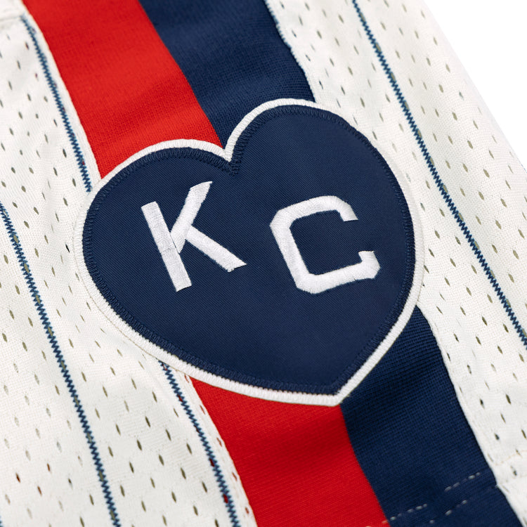 The EFF Kansas City Monarchs NLB Pinstripe Button Down Jersey features a navy heart patch with white KC lettering, and classic blue and red pinstripes inspired by the Negro National League era.