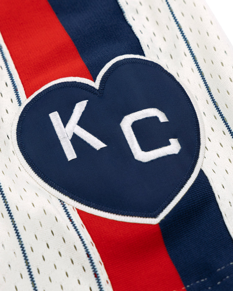 The EFF Kansas City Monarchs NLB Pinstripe Button Down Jersey features a navy heart patch with white KC lettering, and classic blue and red pinstripes inspired by the Negro National League era.