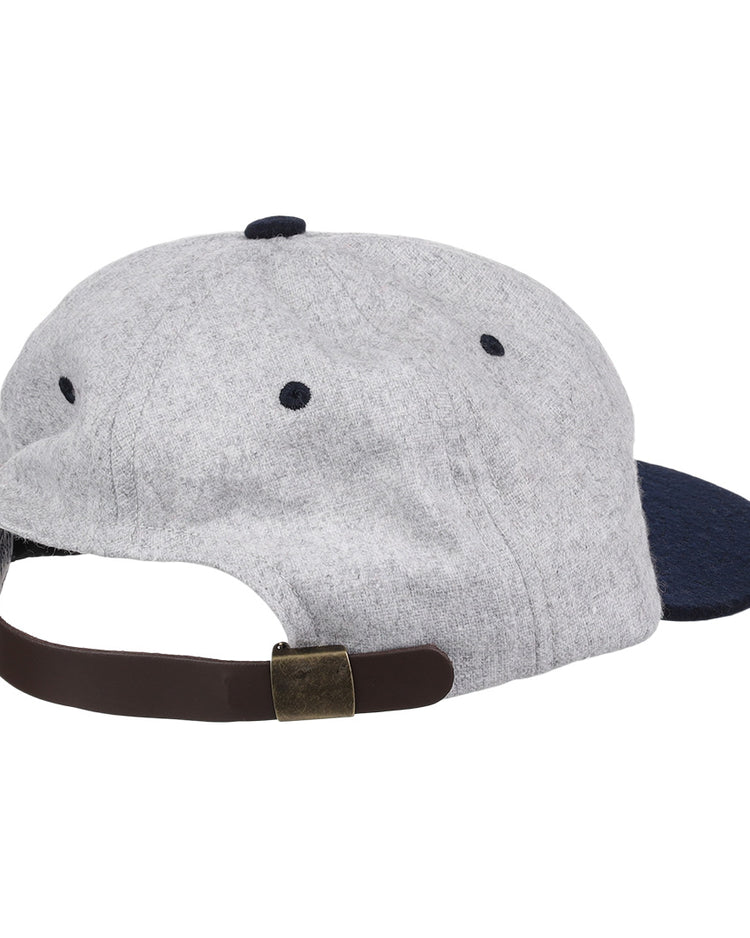 The EFF University of Nevada Wolf Pack Mascot Collegiate Wool Ballcap is shown from the back in grey and navy, featuring a brown adjustable strap with a brass-colored buckle. This is an officially licensed college vault item.