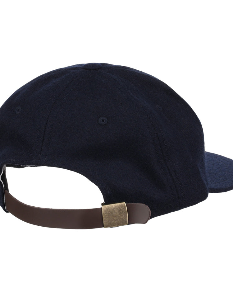 The EFF University of Nevada Wolf Pack Patch Collegiate Wool Ballcap is navy blue with a vintage look, shown from the back, featuring a rounded crown, visible stitching, and a brown adjustable leather strap with brass buckle.