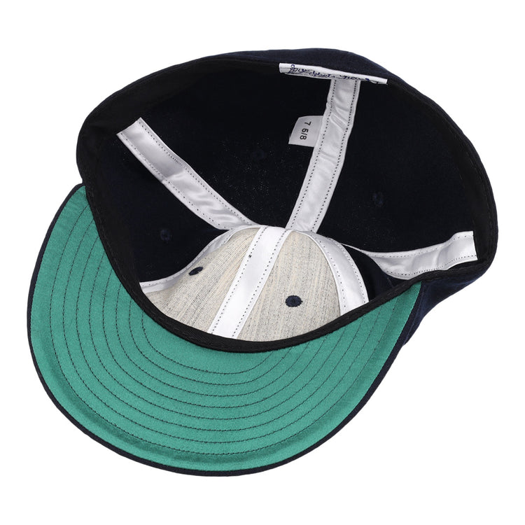 The image shows the inside of a University of Nevada Wolf Pack Patch Collegiate Wool Ballcap by EFF, featuring a green underside brim, white seam strips, gray crown, and a visible size tag along the inner band.