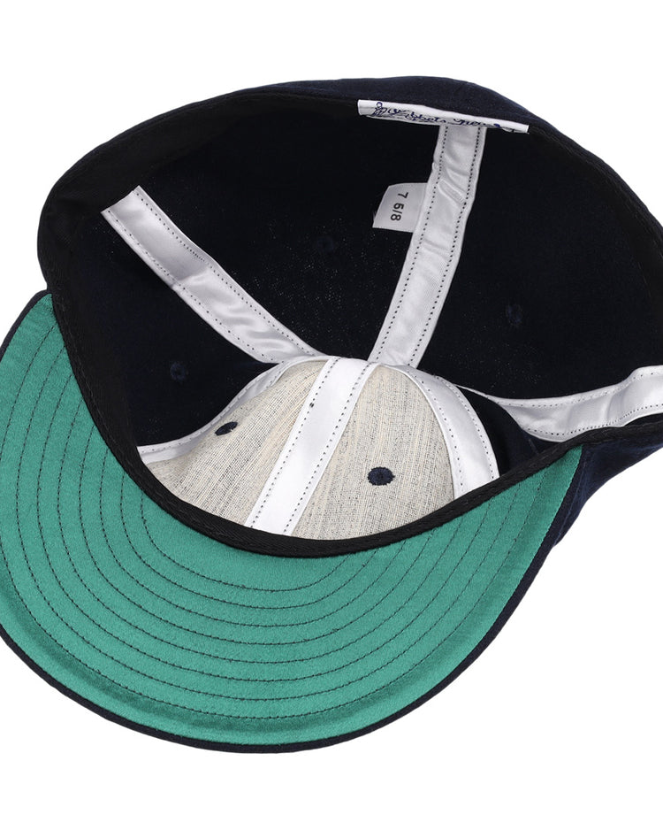 The image shows the inside of a University of Nevada Wolf Pack Patch Collegiate Wool Ballcap by EFF, featuring a green underside brim, white seam strips, gray crown, and a visible size tag along the inner band.