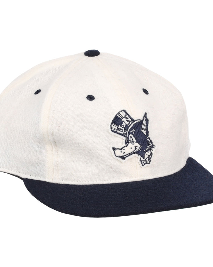 The EFF University of Nevada Wolf Pack Mascot Collegiate Wool Ballcap in white features a navy brim and button, plus an embroidered Wolf Pack logo—perfect for standout collegiate style.