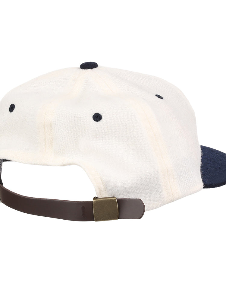 A white University of Nevada Wolf Pack Mascot Collegiate Wool Ballcap by EFF, viewed from the back, features a navy brim and a brown adjustable strap with brass buckle for a classic vintage touch.