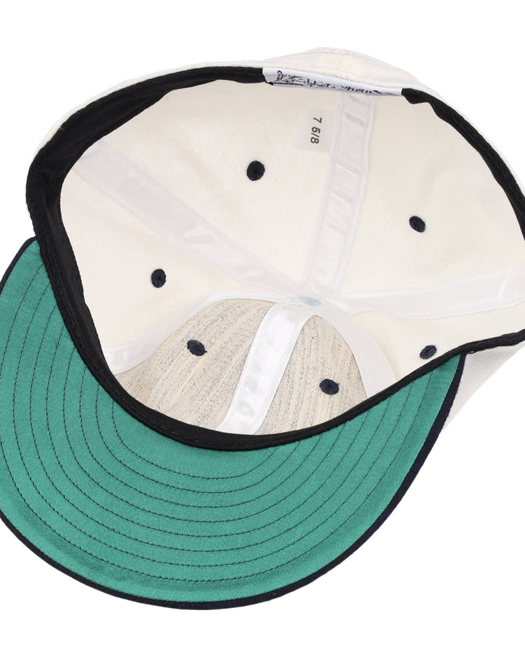 The image shows the inside of an EFF University of Nevada Wolf Pack Mascot Collegiate Wool Ballcap in white, featuring a green underbrim, black edge trim, size tag “7 5/8,” black ventilation holes, and stitched interior panels.