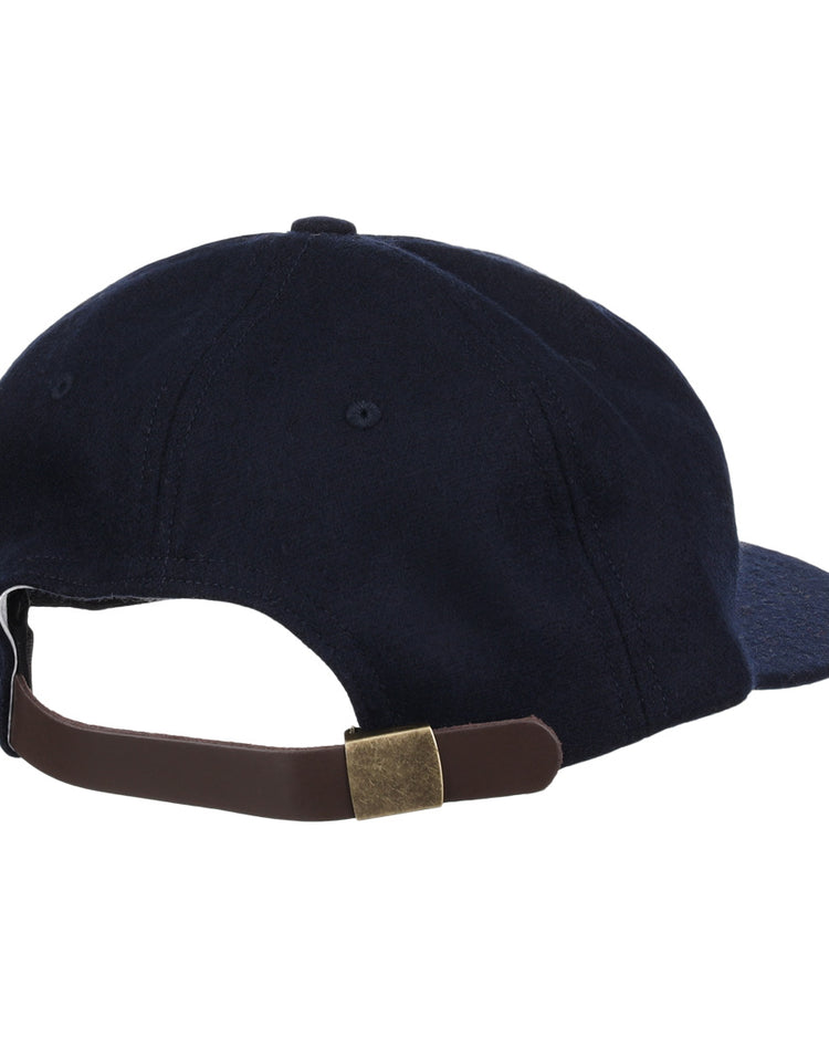 The EFF Cal State Fullerton 1965 Vintage Ballcap is shown from the back in navy blue, featuring a brown adjustable strap with a brass buckle.