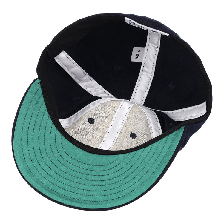 The image shows the inside of an EFF Cal State Fullerton 1965 Vintage Ballcap with a green brim, white lining, white inner tag labeled 7 5/8, navy blue crown, and light gray genuine wool interior.