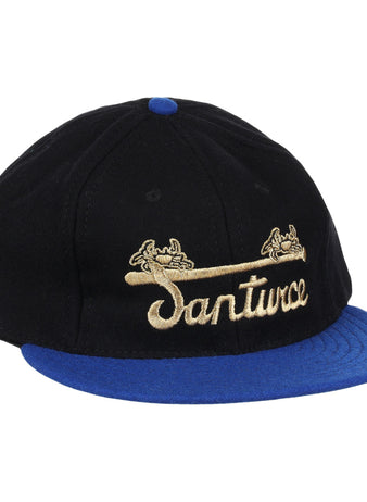 The EFF Santurce Cangrejeros Gilded Collection Ballcap features a black crown, blue brim, gold scroll details, and Santwoz gold script embroidery—a striking nod to the Puerto Rico League.