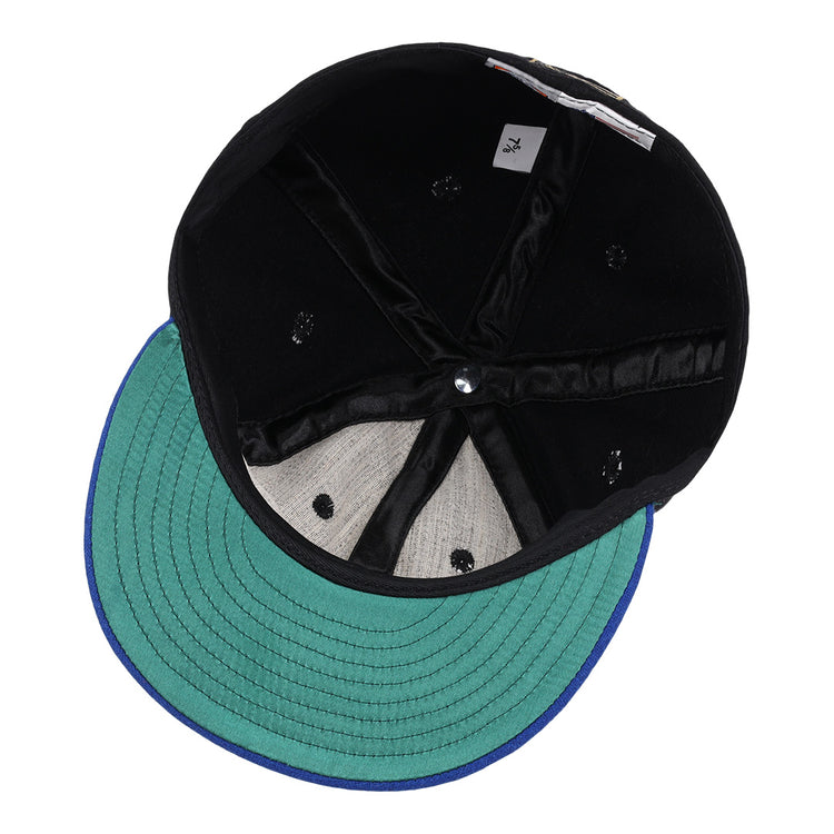 A top-down view of the EFF Santurce Cangrejeros Gilded Collection Ballcap, showing its black design, green visor, blue trim, visible stitching, sweatband, size tag, and interior lining.