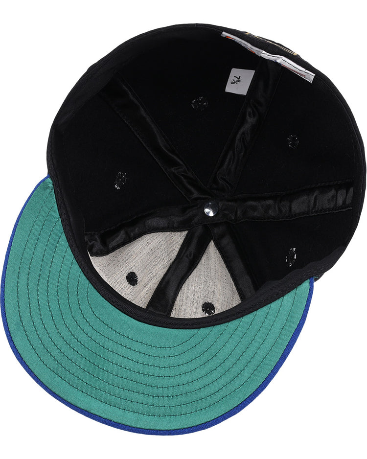A top-down view of the EFF Santurce Cangrejeros Gilded Collection Ballcap, showing its black design, green visor, blue trim, visible stitching, sweatband, size tag, and interior lining.