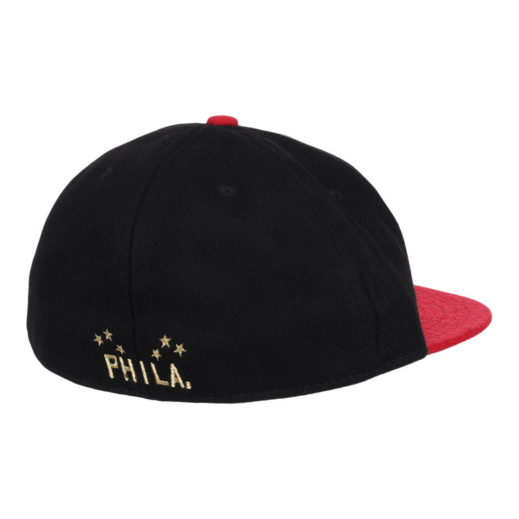 The EFF Philadelphia Stars Gilded Collection Ballcap is a vintage-style black cap with a red brim and top button, PHILA. on the front, and a gold embroidered logo with four stars on the back honoring the Negro National League.