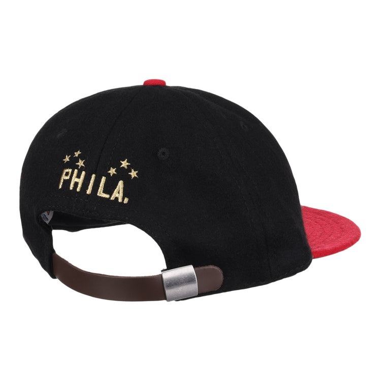 The EFF Philadelphia Stars Gilded Collection Ballcap is a vintage-style hat with a red brim and adjustable brown strap. PHILA. and five gold stars, honoring the Negro National League, are embroidered above the clasp.