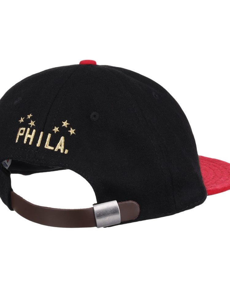 The EFF Philadelphia Stars Gilded Collection Ballcap is a vintage-style hat with a red brim and adjustable brown strap. PHILA. and five gold stars, honoring the Negro National League, are embroidered above the clasp.