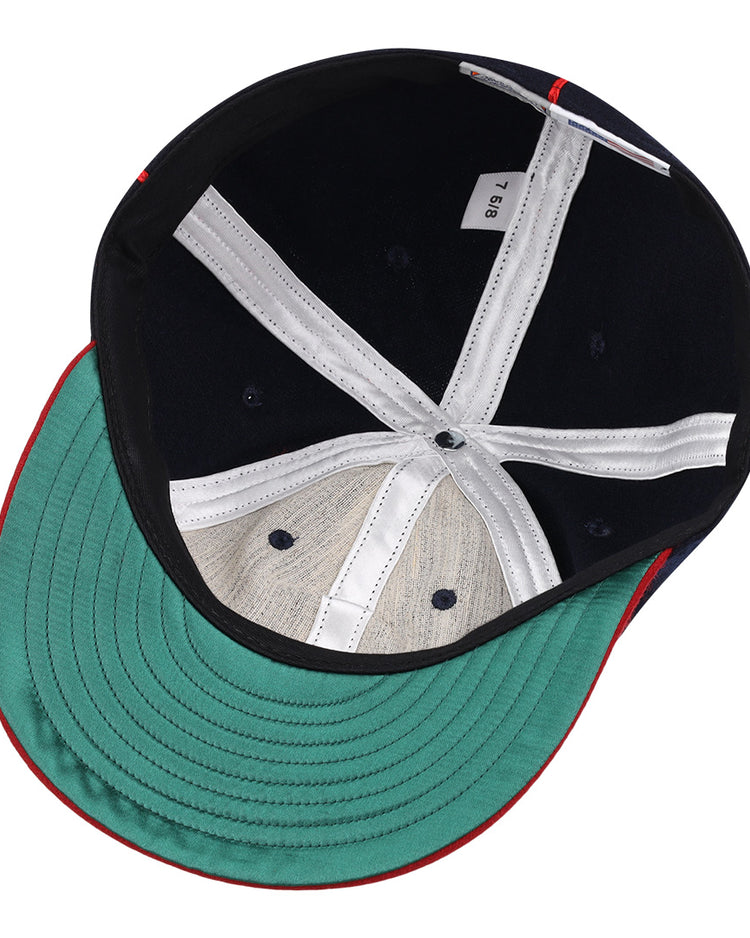 An overhead view of the Lincoln Giants 1911 Vintage Ballcap by EFF shows a green underbrim, white inner seams, a small fabric tag, and black and beige lining—details reminiscent of classic Negro League memorabilia.