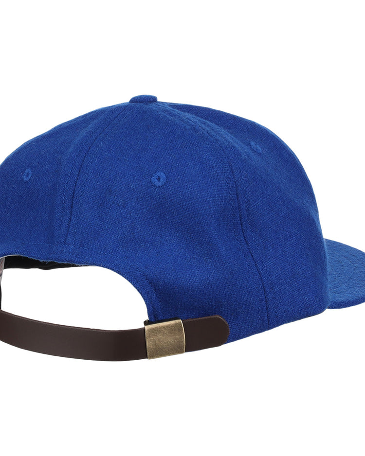 The EFF Royal Ponciana Giants 1912 Vintage Ballcap is blue, viewed from the back, and features a brown adjustable strap with a brass buckle, inspired by the classic wool caps of the 1912 ballclub.