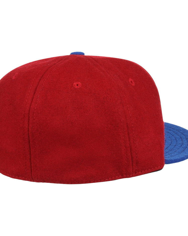 The EFF Memphis Red Sox 1946 Vintage Ballcap, a red wool cap with blue brim, is shown from back and side on a white background, echoing the classic style of the Negro American League team.
