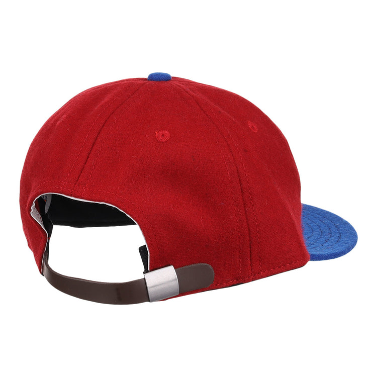 The Memphis Red Sox 1946 Vintage Ballcap by EFF features red and blue wool, a brown adjustable strap with a silver buckle, and classic details inspired by Negro American League styles.