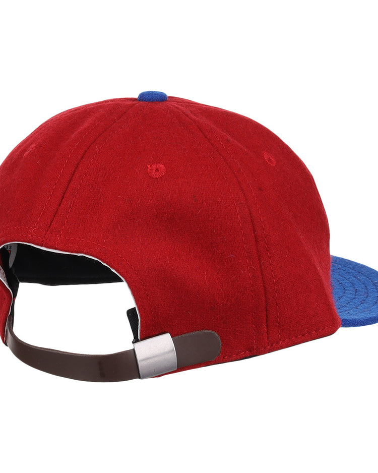 The Memphis Red Sox 1946 Vintage Ballcap by EFF features red and blue wool, a brown adjustable strap with a silver buckle, and classic details inspired by Negro American League styles.