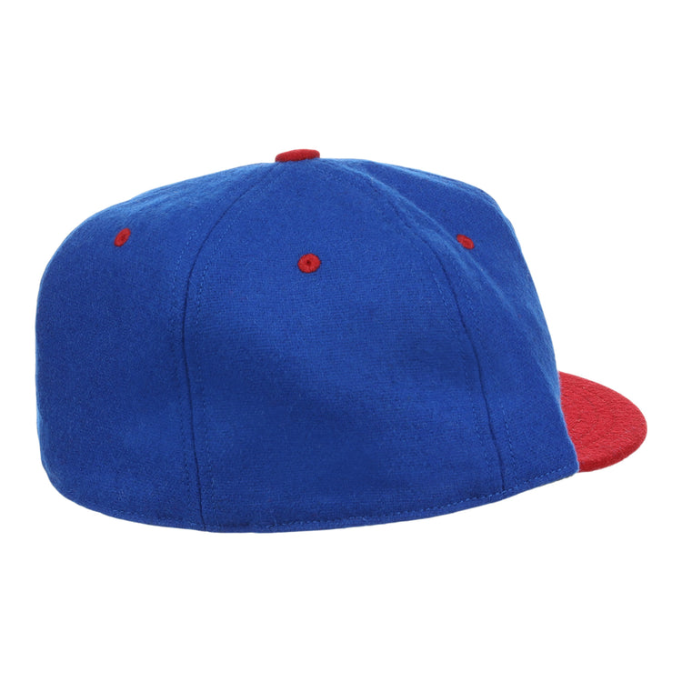The EFF Nashville Cubs 1946 Vintage Ballcap features blue wool with a red brim, top button, and eyelets—modeled after the 1946 Negro Southern League cap—shown from a rear side angle on a white background.