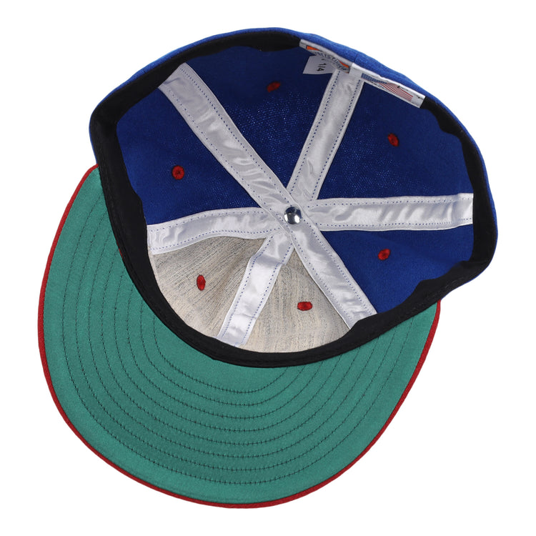 An image displays the inside of the EFF Nashville Cubs 1946 Vintage Ballcap, featuring a blue crown, green brim, red accents, and white inner bands with visible stitching and structural support.