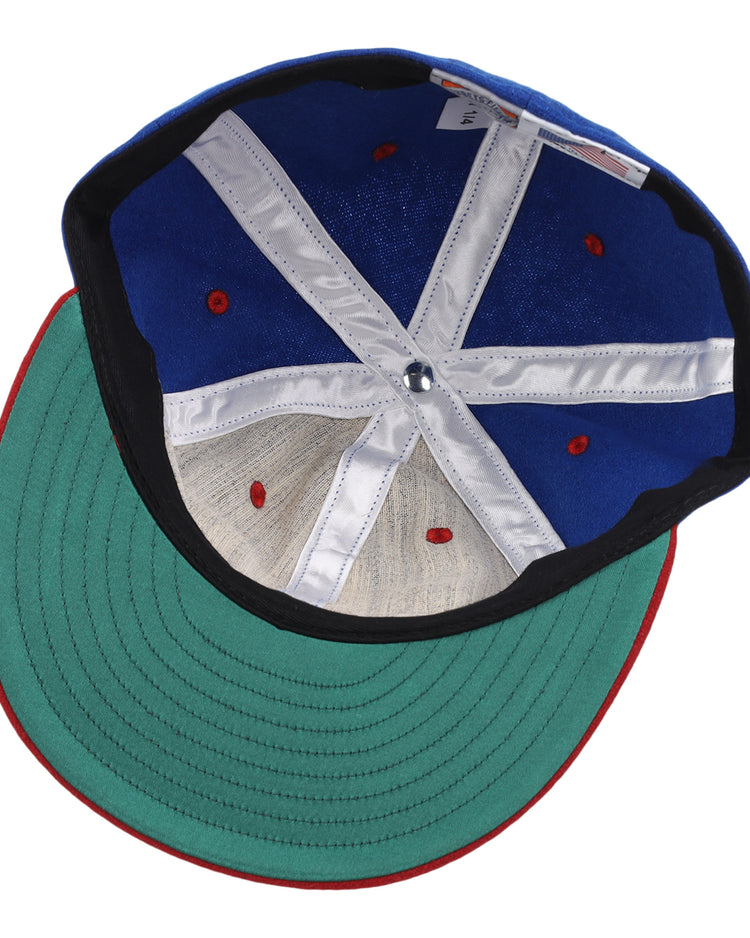 An image displays the inside of the EFF Nashville Cubs 1946 Vintage Ballcap, featuring a blue crown, green brim, red accents, and white inner bands with visible stitching and structural support.