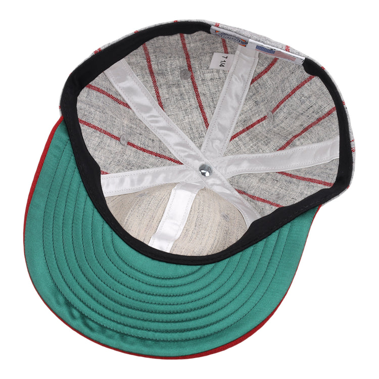 The image displays the inside of an EFF Indianapolis ABCs 1916 Vintage Ballcap, featuring a green brim, red stitching, fabric liner, silver top button, and a white 7 1/4 size tag reminiscent of classic Negro Leagues style.
