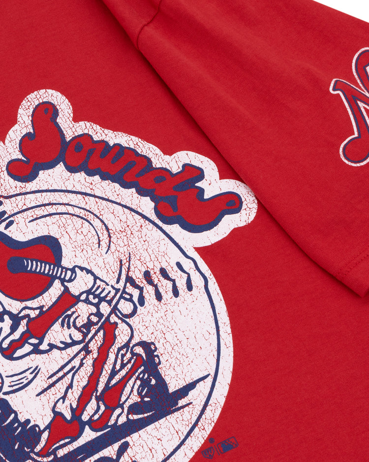 The Ebbets Field Flannels Nashville Sounds EFF MiLB Vintage T-Shirt features red premium cotton, a vintage baseball player graphic, The Sounds text above, and a white N logo on the sleeve.