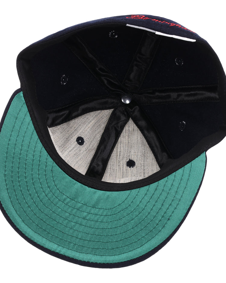 An overhead view of the EFF Birmingham Barons Letterhead Wool Vintage Ballcap shows its green underbrim, grey crown lining, black inner seams, and classic metal rivet—hallmarks of an authentic wool ballcap.