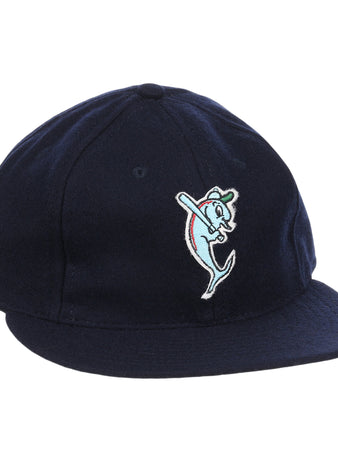 The EFF Tampa Tarpons Letterhead Wool Vintage Ballcap is a navy blue cap with a cartoon dolphin mascot in a green cap and red bat, inspired by Minor League baseball and the playful spirit of the Tampa Tarpons.