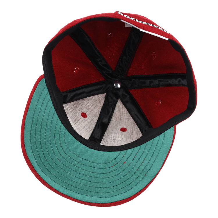 An overhead look at the Rochester Red Wings Letterhead Wool Vintage Ballcap by EFF shows the red caps green underbrim, black seam lining, and part of ROCHESTER visible on the inner label.