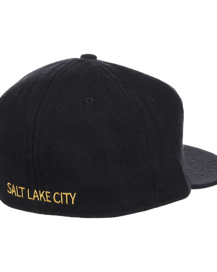 The Salt Lake City Bees Letterhead Wool Vintage Ballcap by EFF is a black wool cap with SALT LAKE CITY embroidered in yellow on the back left, shown from a rear side angle against a white background and styled like a classic Minor League cap.