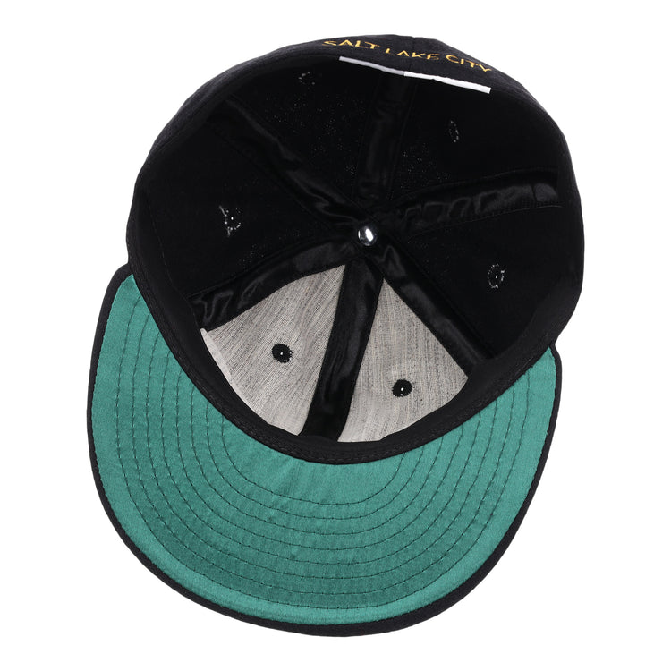 The interior of the black EFF Salt Lake City Bees Letterhead Wool Vintage Ballcap features a green underbill, visible stitching, and Salt Lake City embroidered in yellow, reflecting its Pacific Coast League vintage baseball cap heritage.