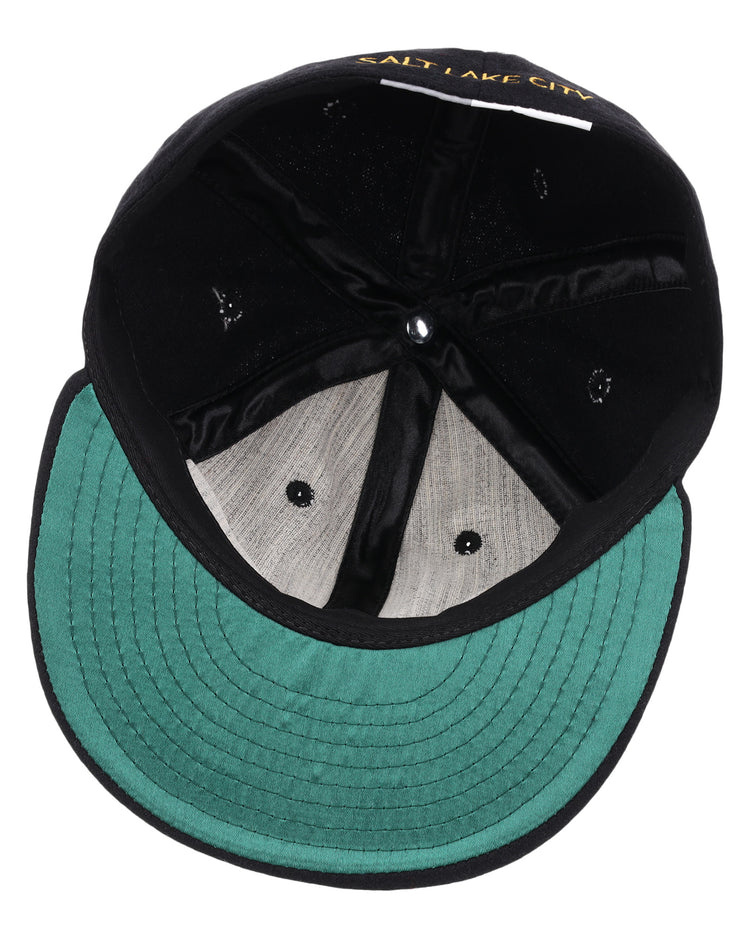 The interior of the black EFF Salt Lake City Bees Letterhead Wool Vintage Ballcap features a green underbill, visible stitching, and Salt Lake City embroidered in yellow, reflecting its Pacific Coast League vintage baseball cap heritage.