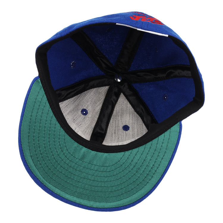 The EFF Columbus Jets Letterhead Wool Vintage Ballcap features a blue wool build, green brim, black inner seams, grey panels, and a white inner tag—capturing the classic style of vintage Minor League baseball caps.