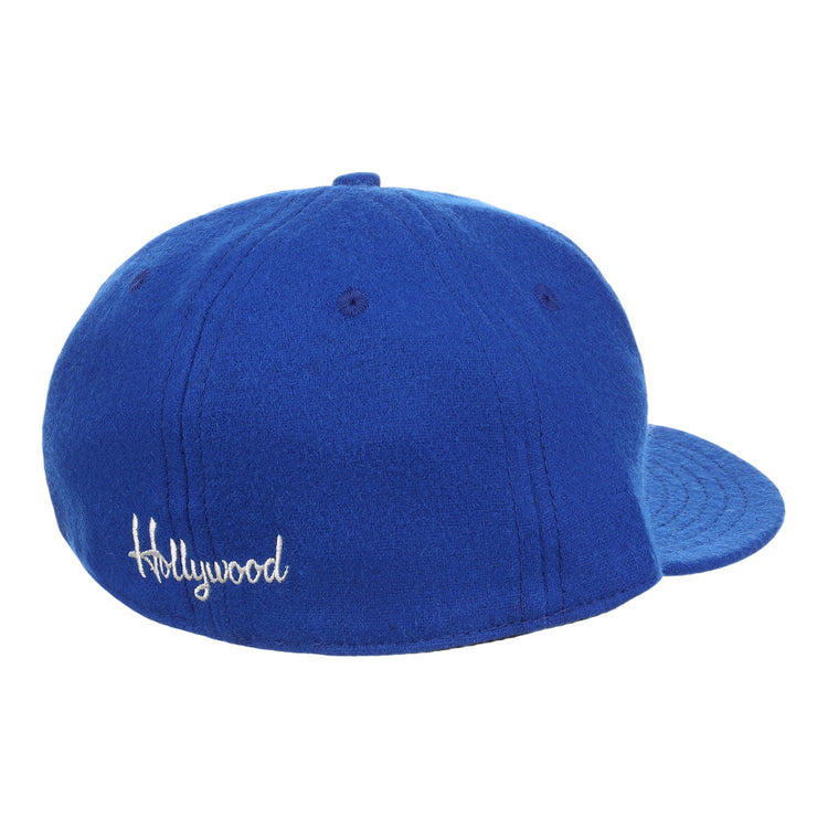 The EFF Hollywood Stars Letterhead Wool Vintage Ballcap is a blue wool hat seen from the back, with Hollywood embroidered in white script—a classic tribute to the Pacific Coast League’s iconic cap.