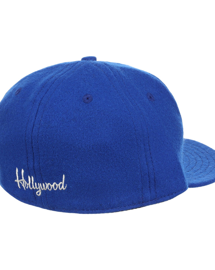 The EFF Hollywood Stars Letterhead Wool Vintage Ballcap is a blue wool hat seen from the back, with Hollywood embroidered in white script—a classic tribute to the Pacific Coast League’s iconic cap.