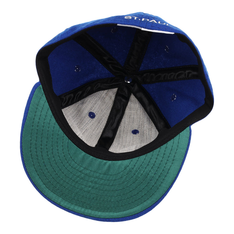 A look inside the EFF St. Paul Saints Letterhead Wool Vintage Ballcap shows a blue crown, green undervisor, black inner band, exposed stitching, and a partially visible label—perfect for vintage Minor League or Saints logo collectors.