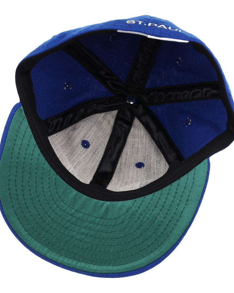 A look inside the EFF St. Paul Saints Letterhead Wool Vintage Ballcap shows a blue crown, green undervisor, black inner band, exposed stitching, and a partially visible label—perfect for vintage Minor League or Saints logo collectors.