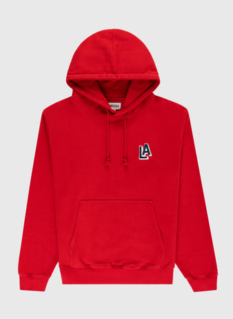 The Ebbets Field Los Angeles Angels (PCL) Heavyweight Cotton Terry Pullover Hoodie is a bright red hoodie with a front pouch pocket and a vintage 1942 LA logo patch on the upper left chest.