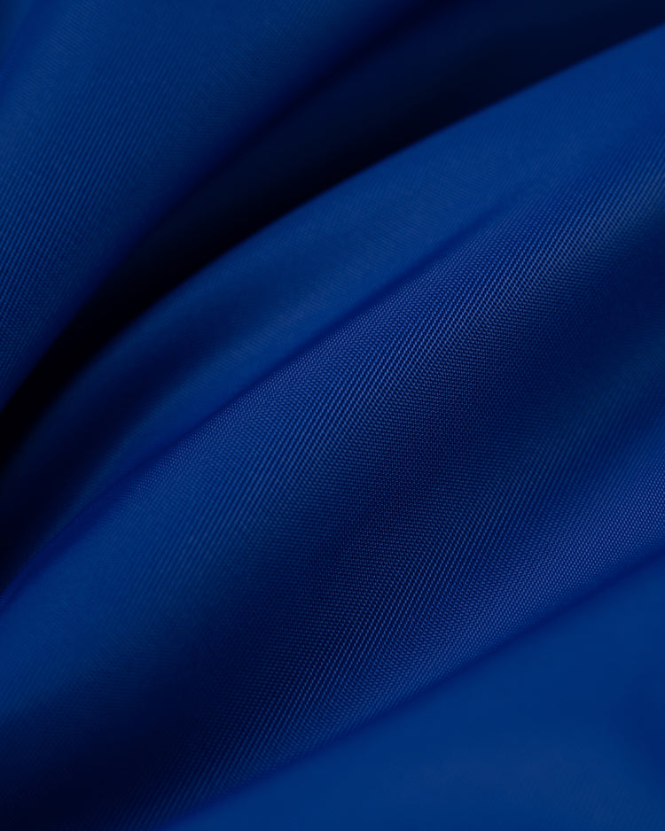 Close-up of the soft, smooth blue fabric with gentle folds and subtle sheen, highlighting the luxurious weave of the Ebbets Field Los Angeles Angels (PCL) Satin Varsity Jacket.