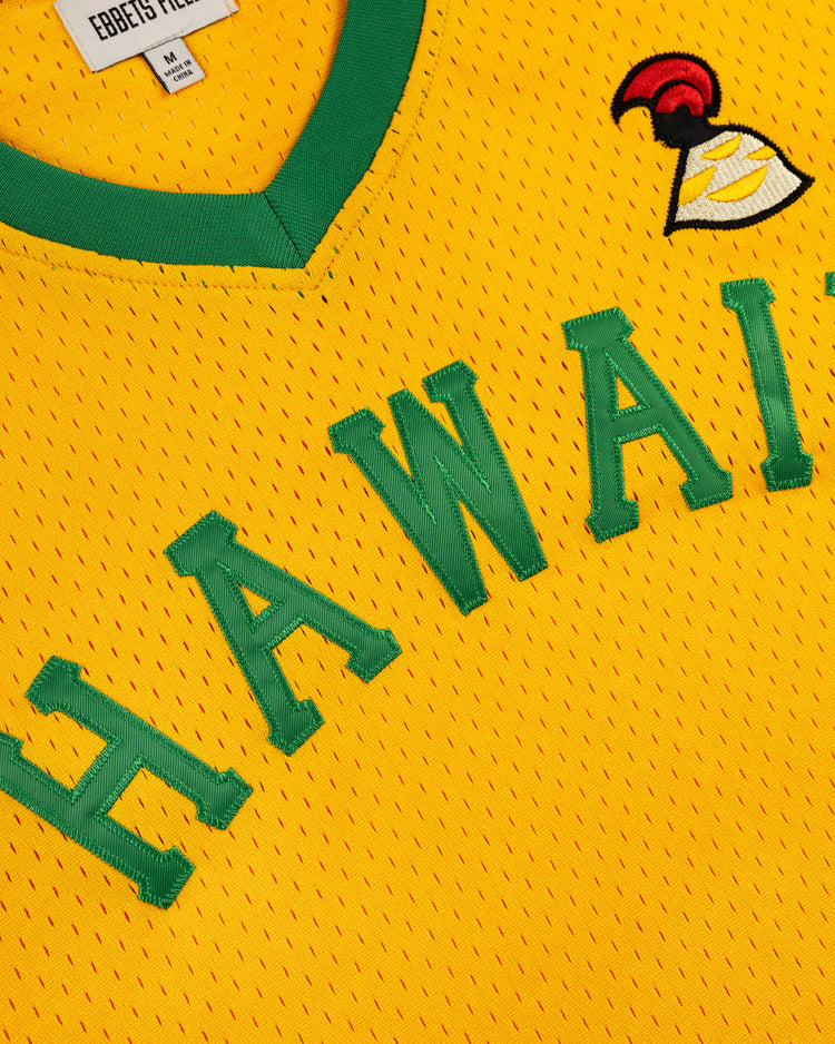 The Ebbets Field Hawaii Islanders (PCL) Mesh V-Neck Jersey features yellow mesh with green trim, HAWAII in green letters, and a small embroidered helmet logo with a red plume, inspired by the classic Islanders jersey.