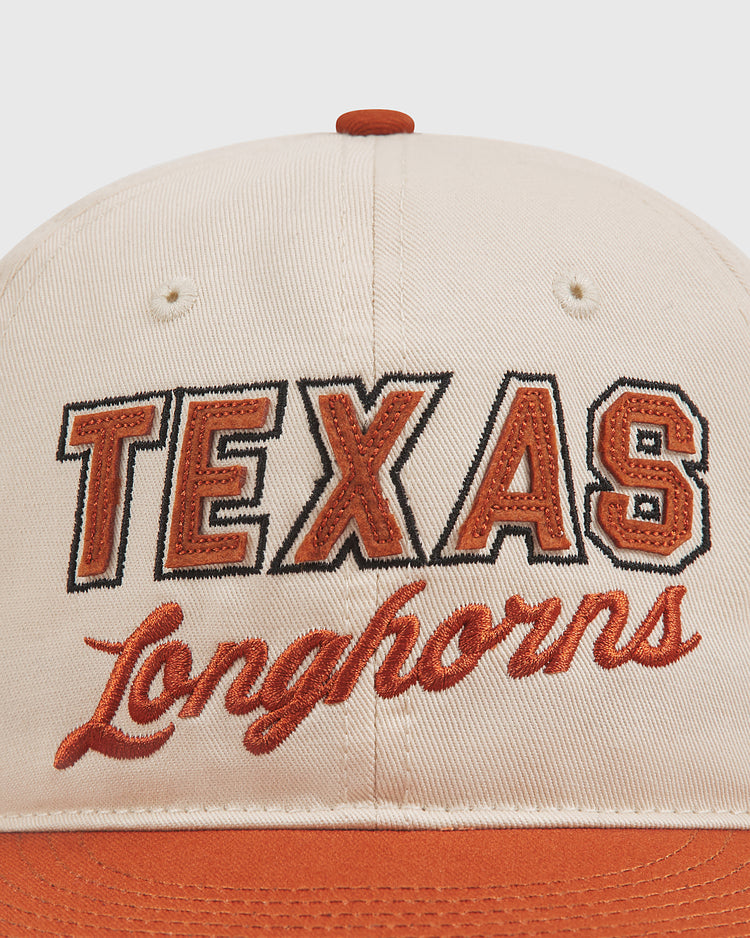 Ebbets Field University of Texas Longhorns Cotton Twill Ballcap in cream and orange, featuring bold embroidered “TEXAS” lettering above “Longhorns” in cursive on the front.