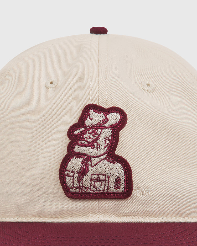 Close-up of the Texas A&M Sarge Cotton Twill Ballcap by Ebbets Field, a beige cotton twill cap with maroon trim and a maroon embroidered Sarge mascot in uniform on the front.