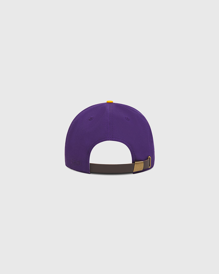 The Ebbets Field University of Washington Cotton Twill Classic Cap is displayed from the back, highlighting its adjustable brown strap with a metal buckle, set against a plain light gray background.
