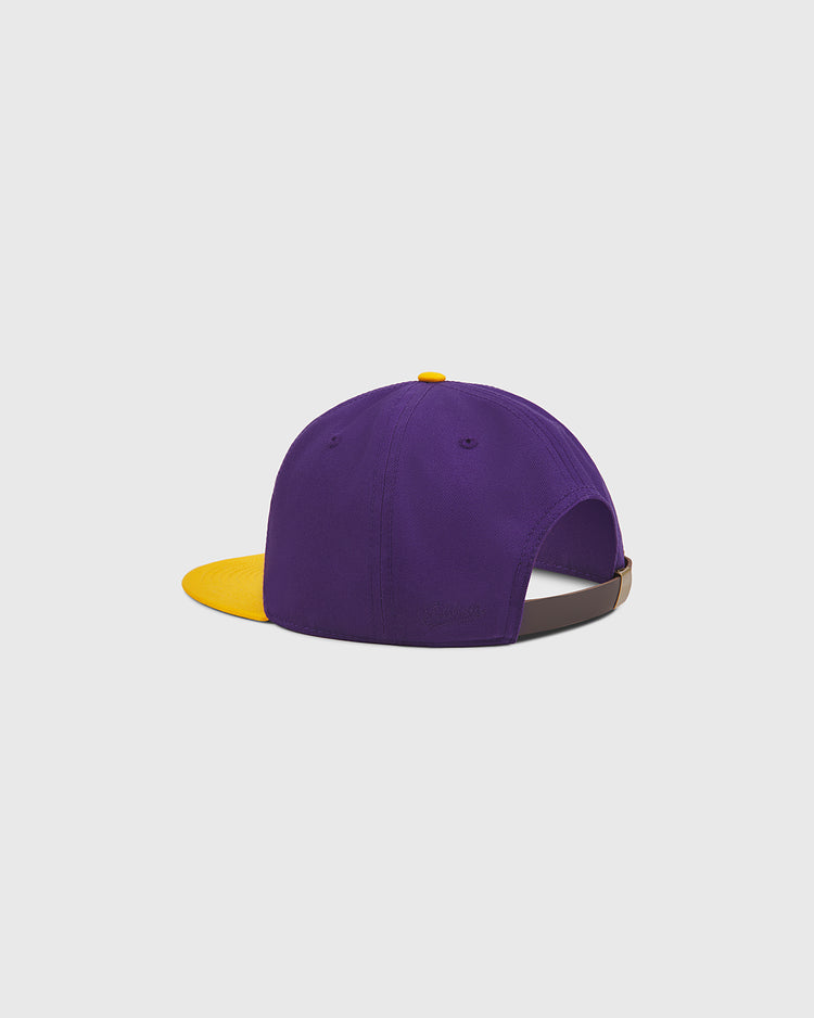 The Ebbets Field University of Washington Cotton Twill Classic Cap features a purple design with a yellow brim and top button, shown from the back with an adjustable strap.