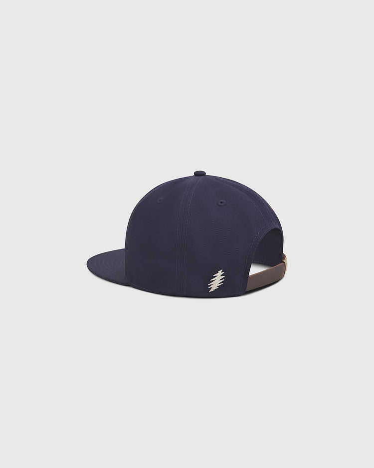 The Ebbets Field Grateful Dead Baseball Bear Cotton Twill Ballcap is pictured from the back against a plain light gray background, featuring a small white lightning bolt logo near the adjustable strap. Crafted from cotton twill, this navy snapback subtly channels classic Grateful Dead ballcap style.