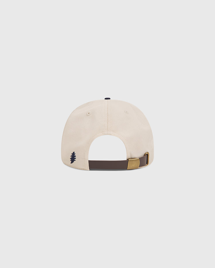The Grateful Dead Baseball Bear Cotton Twill Ballcap by Ebbets Field is pictured from the back, highlighting its beige cotton twill fabric, a dark brown adjustable strap with a brass buckle, and a small black tree logo embroidered near the opening. Set against a plain white background, this cap reflects the timeless style of classic Grateful Dead ballcaps.